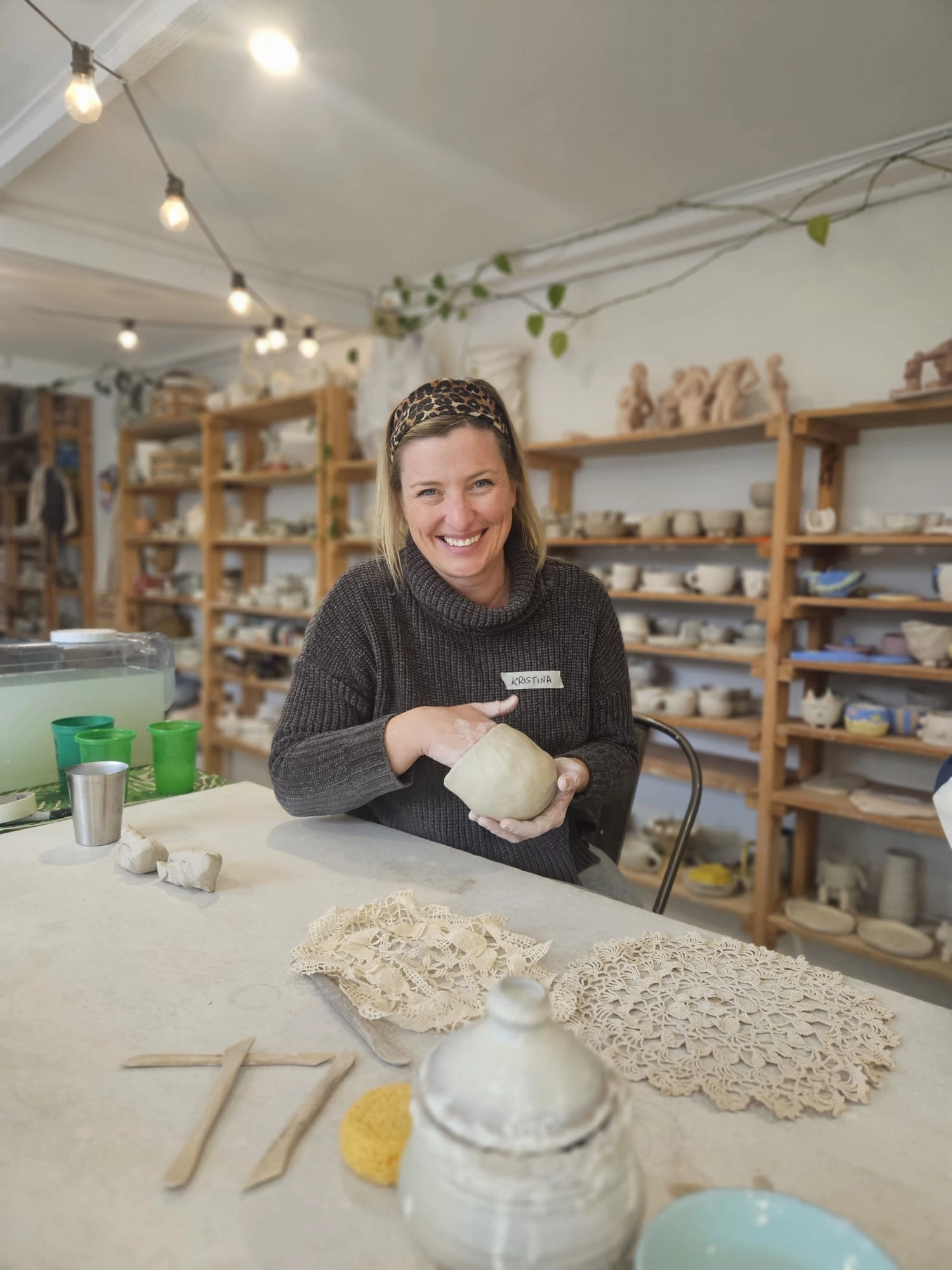 Kristina Agustin smiling while making pottery in a workshop